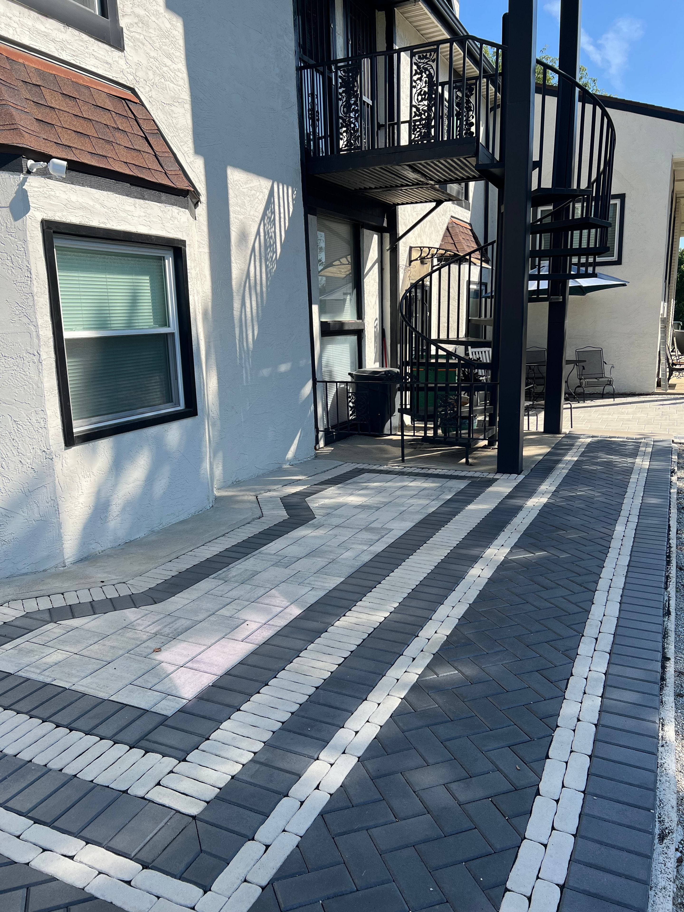 Paver patio hardscape installation in a residential backyard